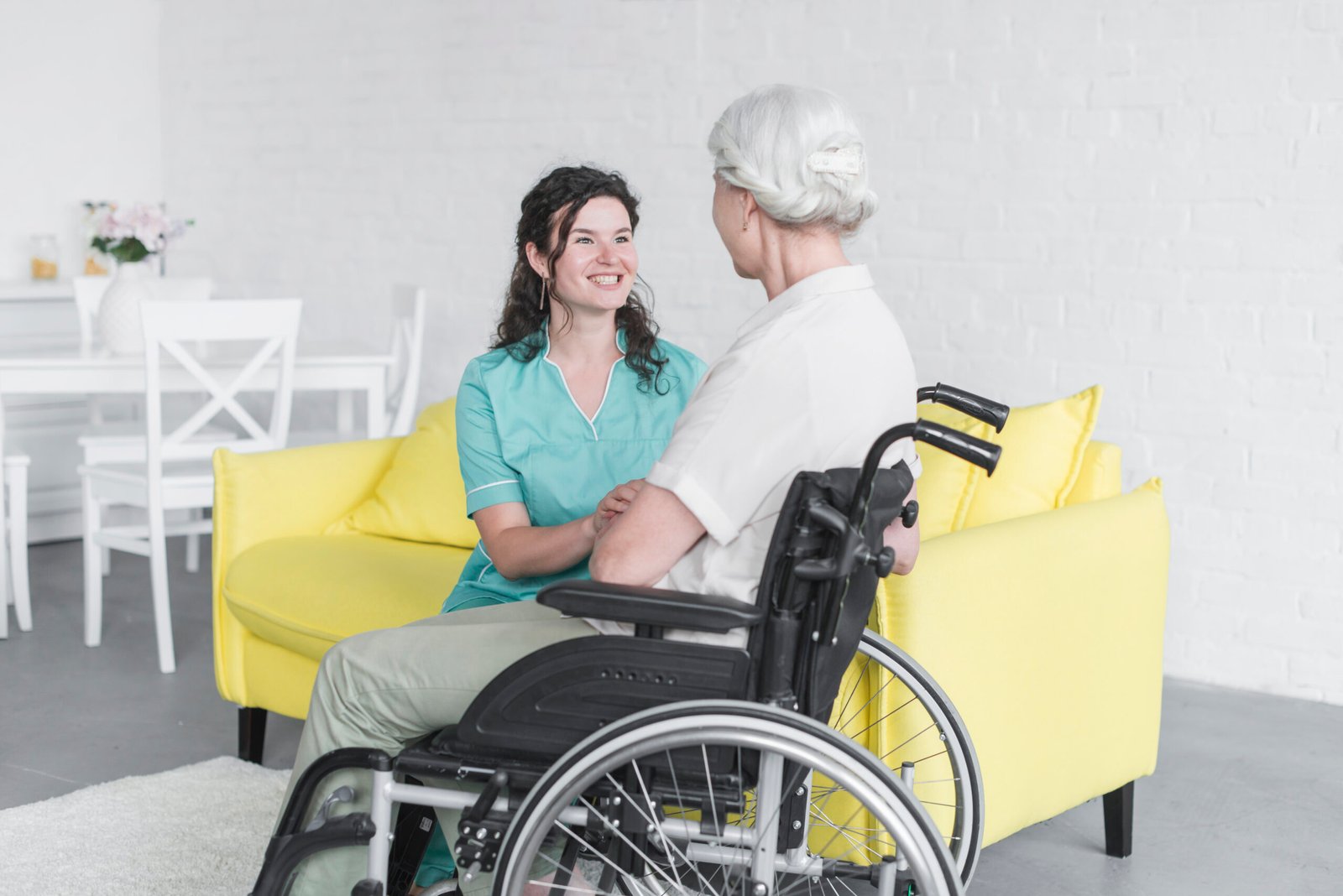 smiling-woman-looking-senior-woman-sitting-wheel-chair smiling-woman-looking-senior-woman-sitting-wheel-chair